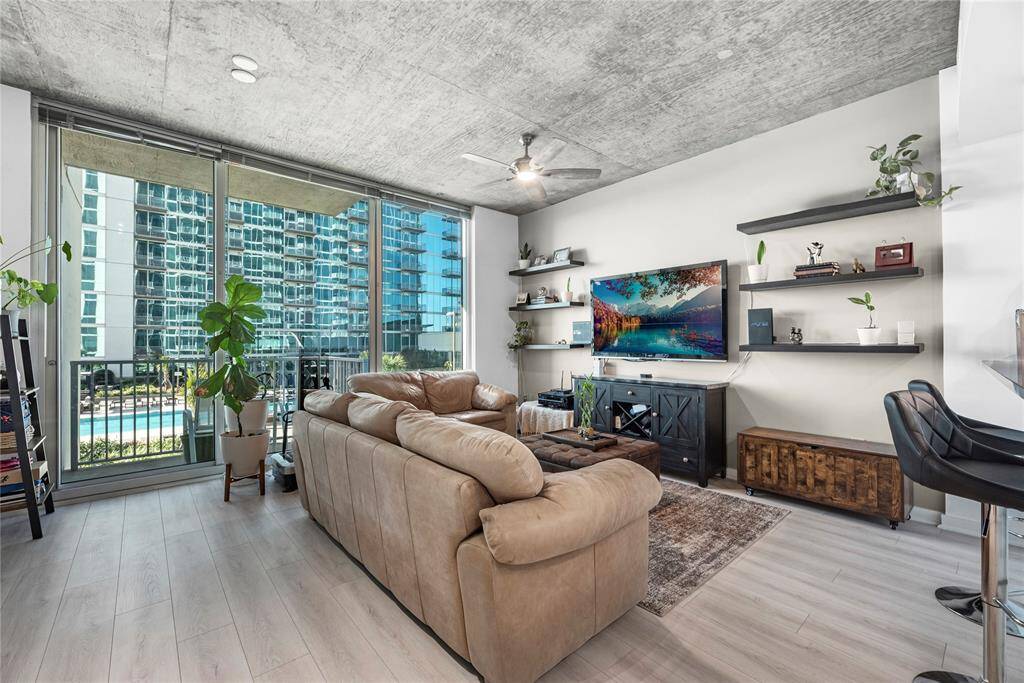 Showcasing expansive floor-to-ceiling windows that flood the sleek, modern interior with natural light