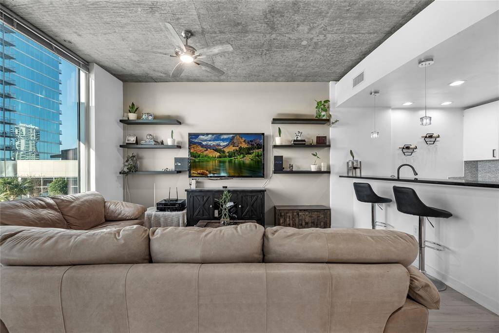 The room is styled with modern sophistication—plush, neutral-toned furnishings