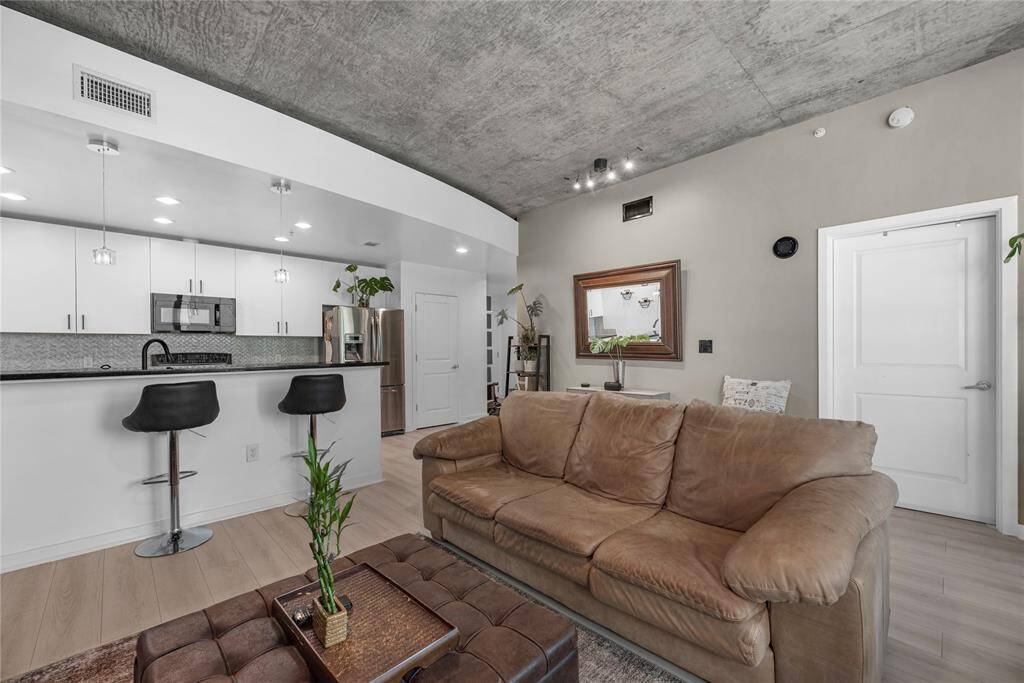 The living room features soft, neutral-toned walls in a warm taupe that effortlessly complement the natural light