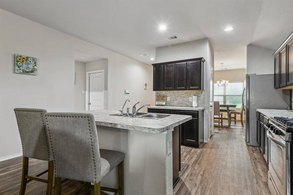 The space connects to a dining area with natural light.