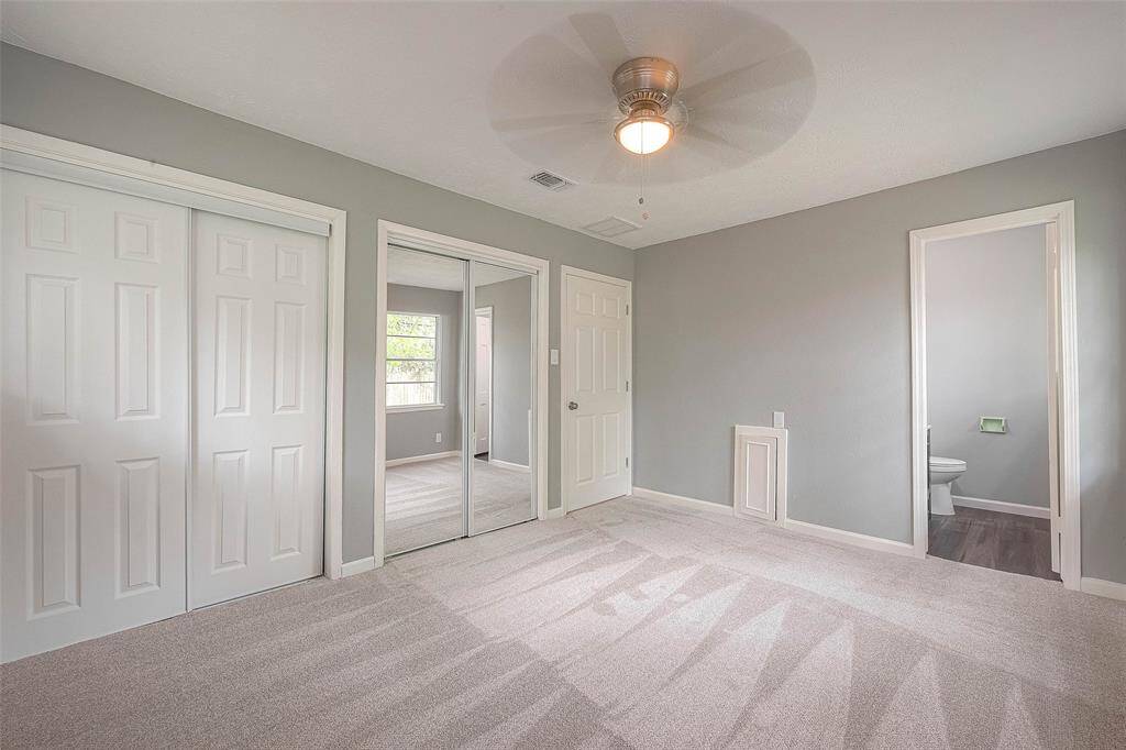 Other view of primary bedroom.
