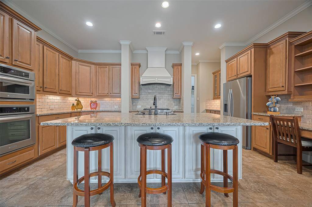 Fall in love with this open kitchen—granite countertops and a large island ready for cooking and gathering.