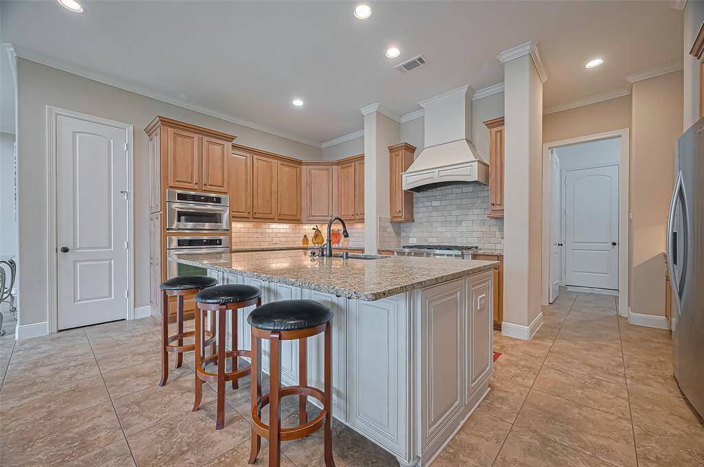 Kitchen featuring granite countertops and stainless steel appliances for a sleek, functional design.