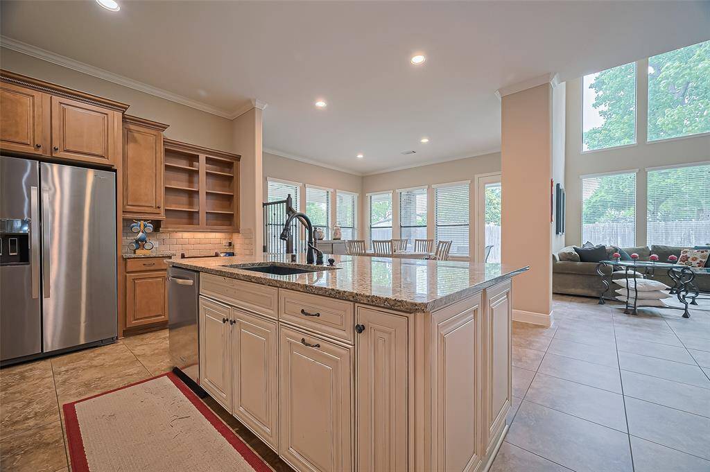 The kitchen offers a spectacular view of the outdoor space, bringing in natural light and scenic charm