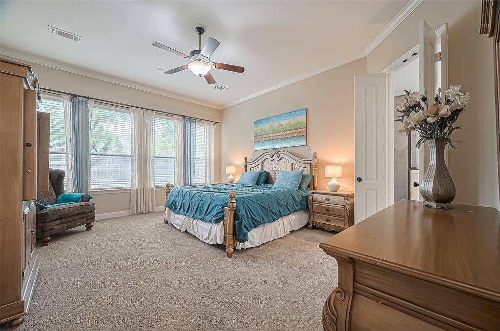Spacious primary bedroom filled with natural light, offering a serene and comfortable retreat.