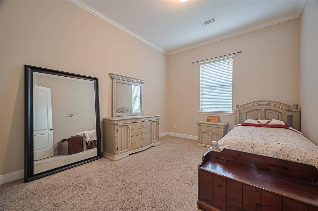 Conveniently located on the main floor, the first secondary bedroom offers comfort and flexibility for guests or multigenerational living.