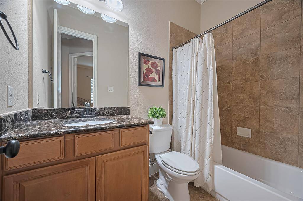 Well-appointed secondary bathroom conveniently serves both the first-floor bedroom and guests.