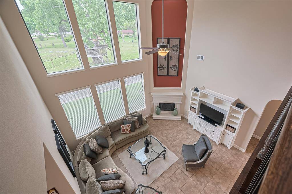 Impressive two-story elevation offering a striking view from the upper level down to the grand living room.
