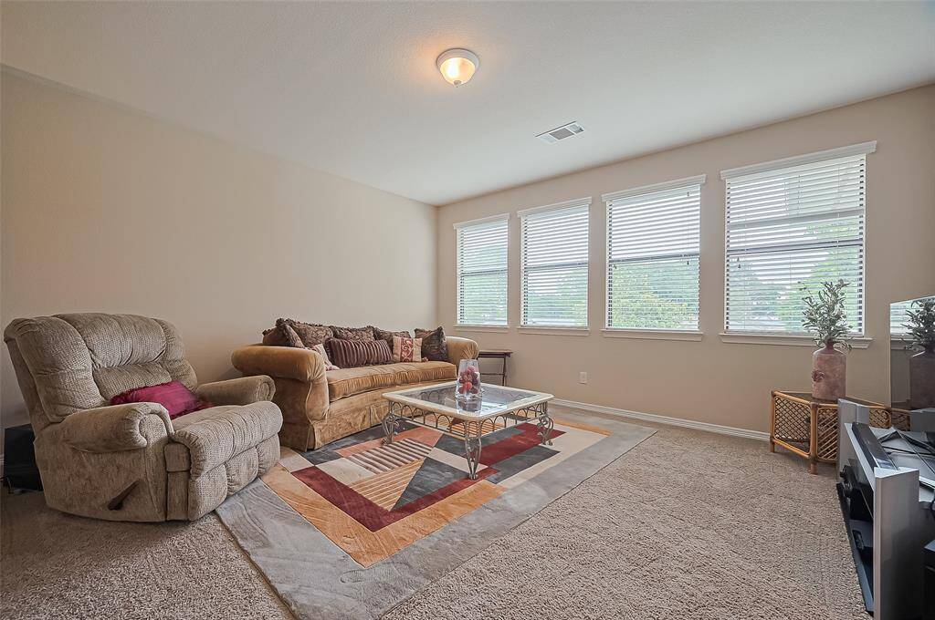 Spacious game room with large windows offering natural light and beautiful views of the outdoor area.
