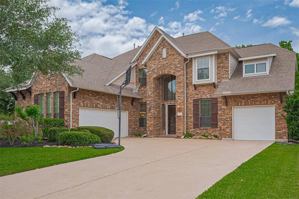 The architecture is classic with modern touches, offering curb appeal and inviting entryway. The spacious driveway and curb appeal make it ideal for family living.