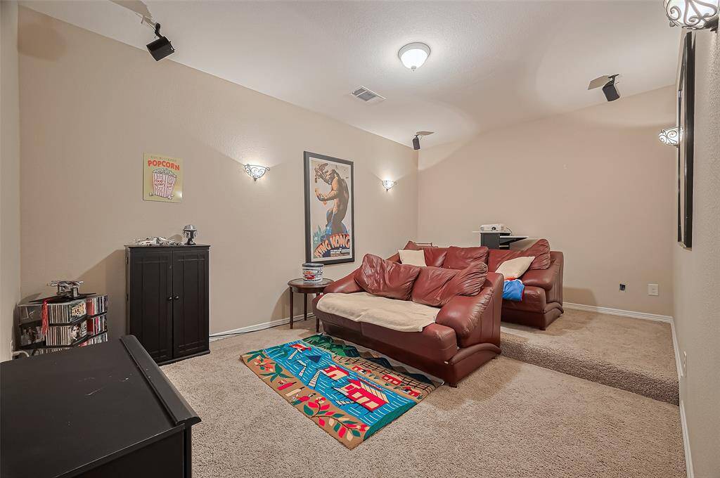 Spacious media room—perfect for enjoying movies, gaming, or relaxing with family in a private setting.