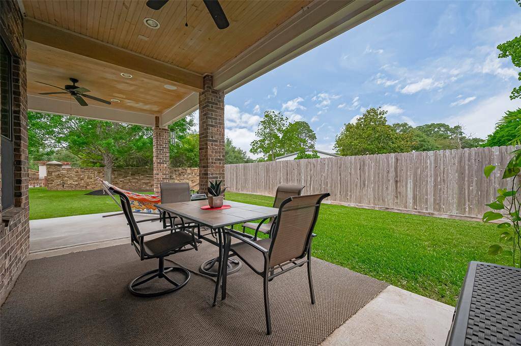 Create your dream outdoor oasis—this oversized covered patio blends seamlessly with nature all around.