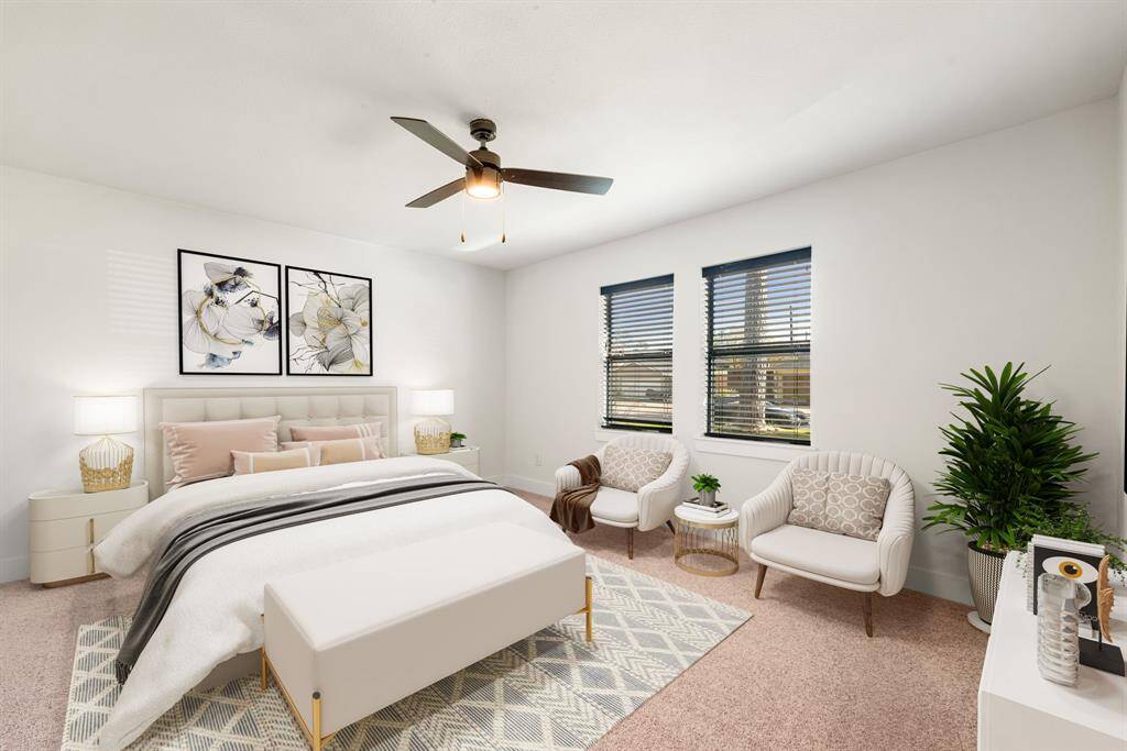 Secondary bedroom great for use as an in-law suite or guest suite features high ceilings, lovely modern ceiling fan, custom paint, plush carpet, space for seating area, direct access to the secondary bathroom and a large window. *Virtually Staged