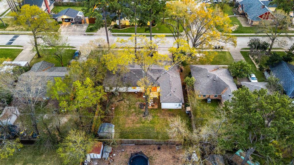Amazing aerial shot of this gorgeous home situated on a quiet street. Lush landscaping, well manicured front lawn and a wonderful back patio perfect to set up, an outdoor sitting area with a beautiful view.