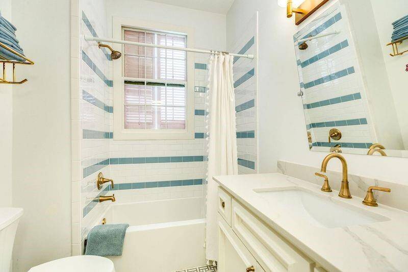 Remodeled secondary bathroom is located in the hallway leading to the guest BR