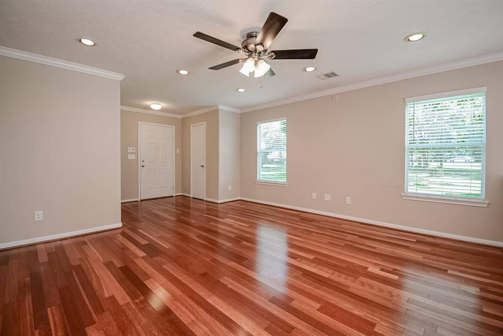 Another view of family/living room. Recessed canned lighting, ceiling fan