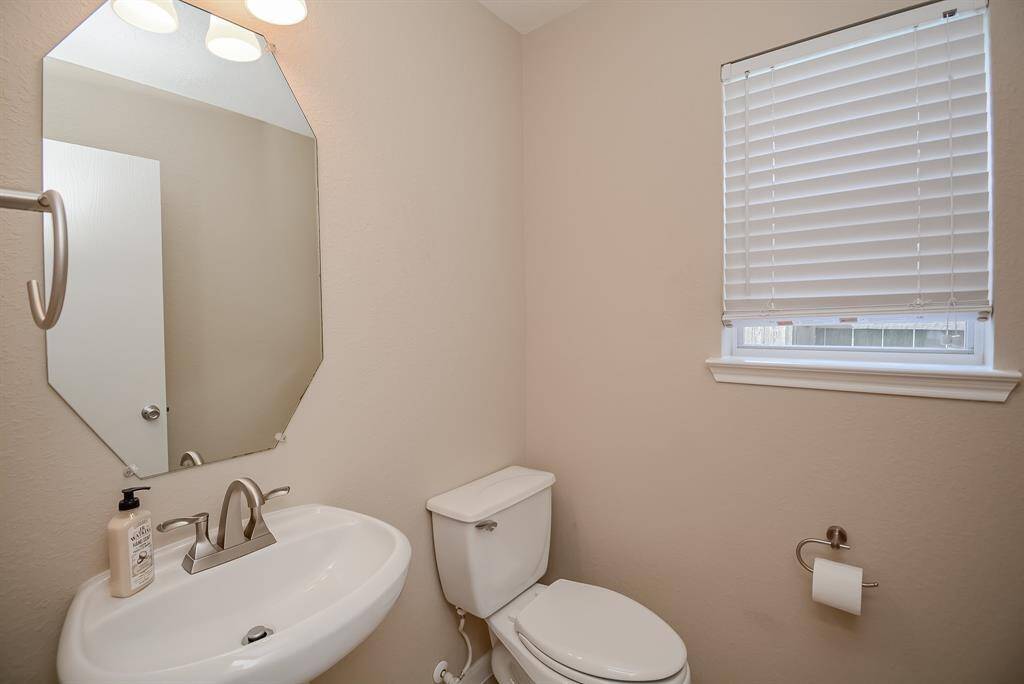 Powder room perfectly located between garage and kitchen, away from the front living area