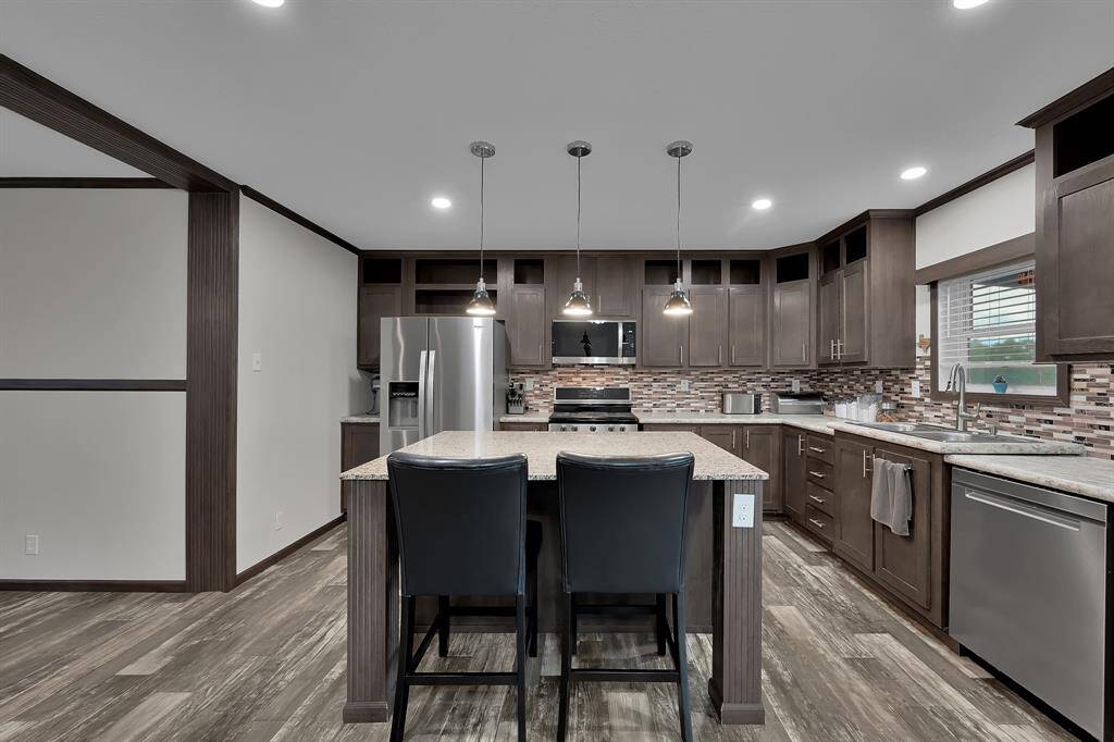 The kitchen island doubles as a breakfast table for those quick on-the-go meals. The kitchen island also features several outlets for all your kitchen accessories.