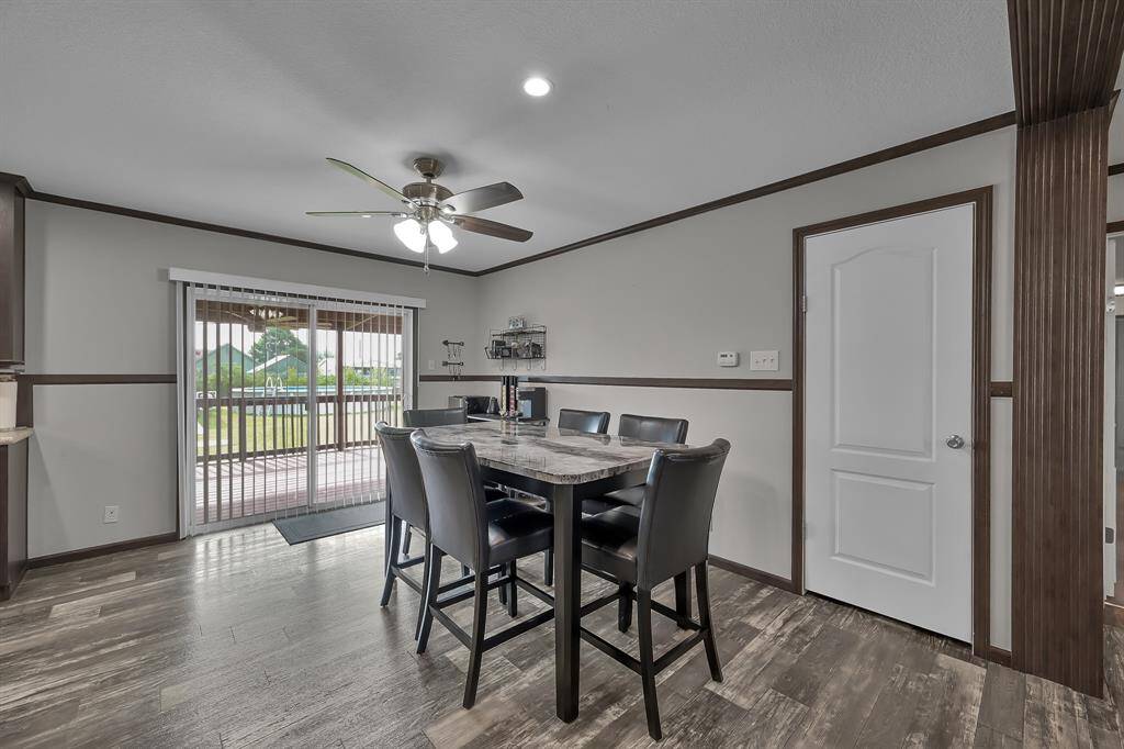 The spacious dining room has a great view of the backyard. The laundry room is located through the door on the right.