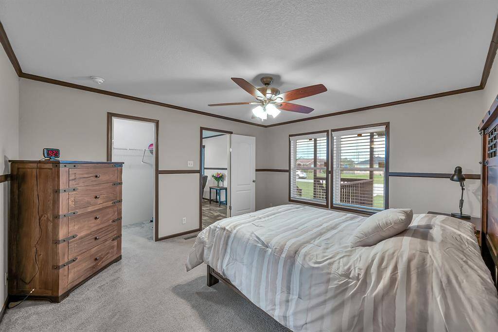 The primary closet is located through the door on the left. This room also has a great view of the front yard.