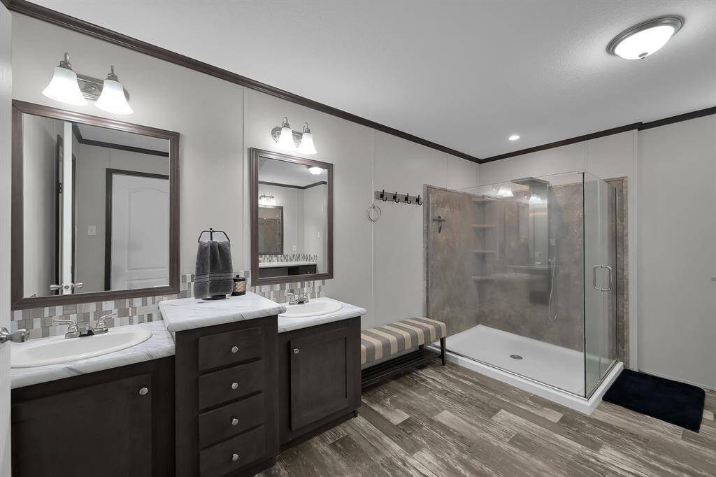 The primary bathroom is HUGE and features dual sinks, an extended standing shower, and a separate vanity.