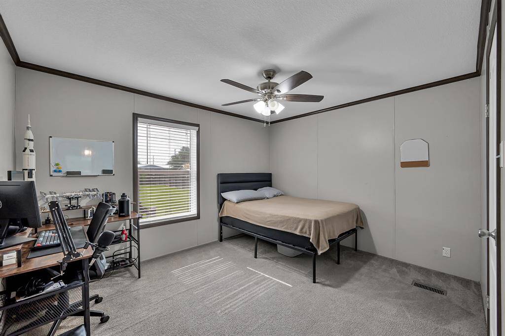 Bedroom two faces the backyard. Did you notice that every room has a ceiling fan? This helps keep those energy bills down during the summer!