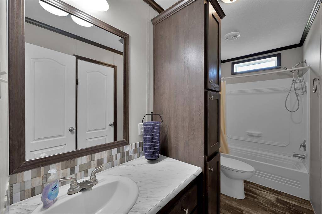 The secondary bathroom has a full size tub/shower combo.