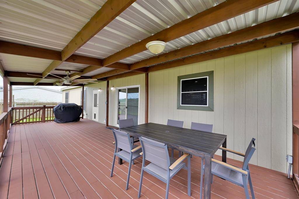 This expansive back covered patio is perfect for entertaining and relaxing outdoors.