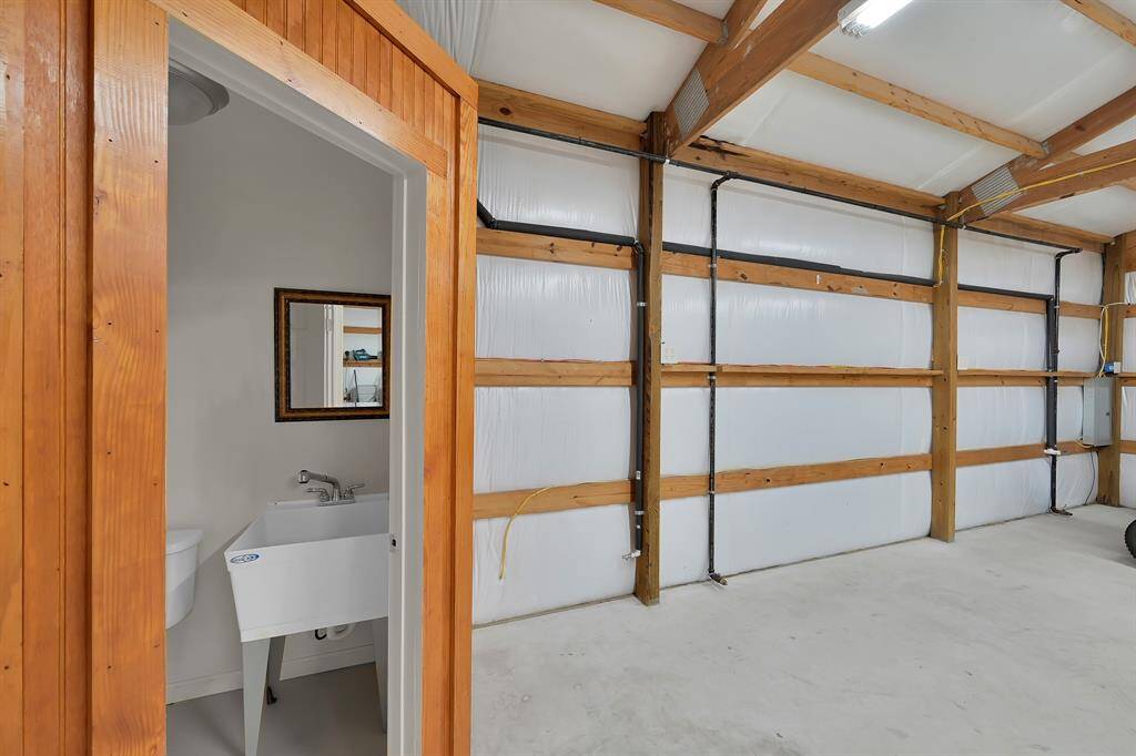 To the left, the half bath, to the right you can see the water and gas hookups. This workshop is also wired for its own separate internet router, which means you don't have to try to connect to the main home's wifi.