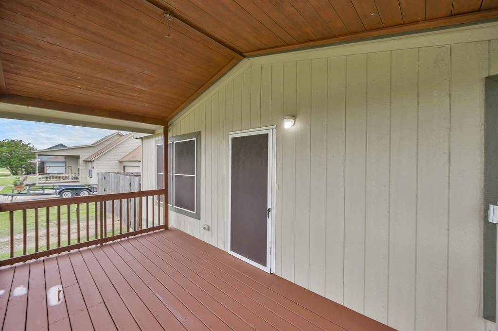 The wood-slat covered patio is a nice touch! Now let's take a look inside!