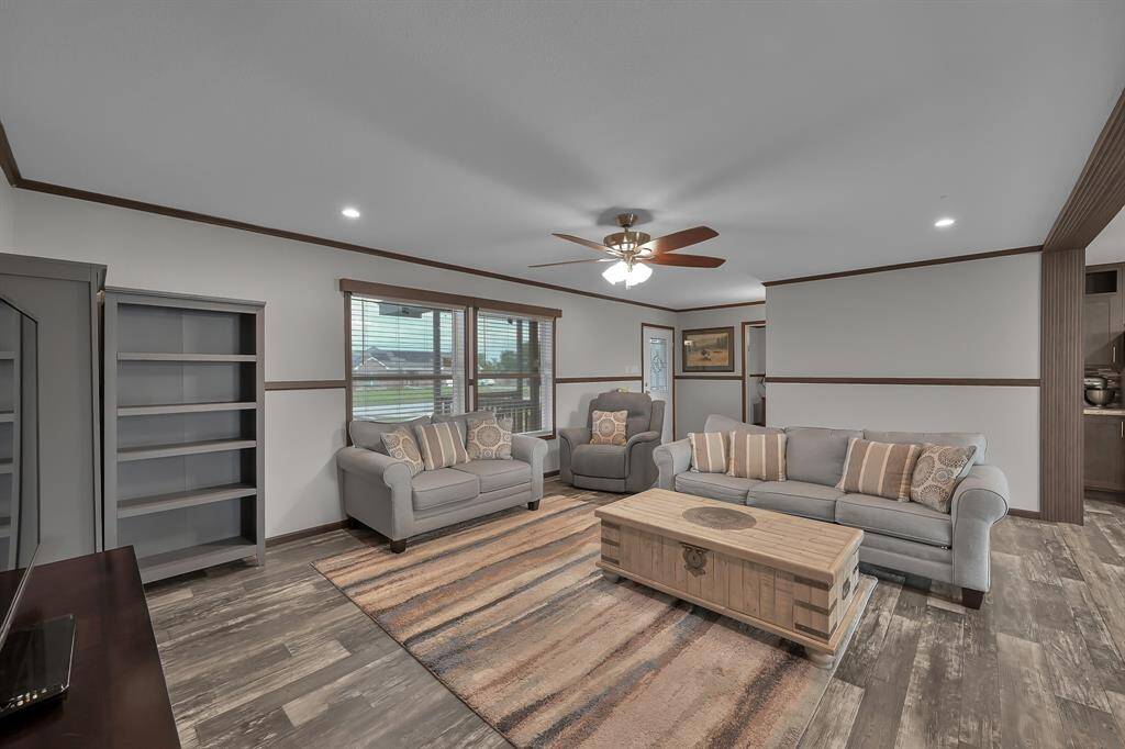 This open floor plan offers a spacious living room, connected with both kitchen and dining.