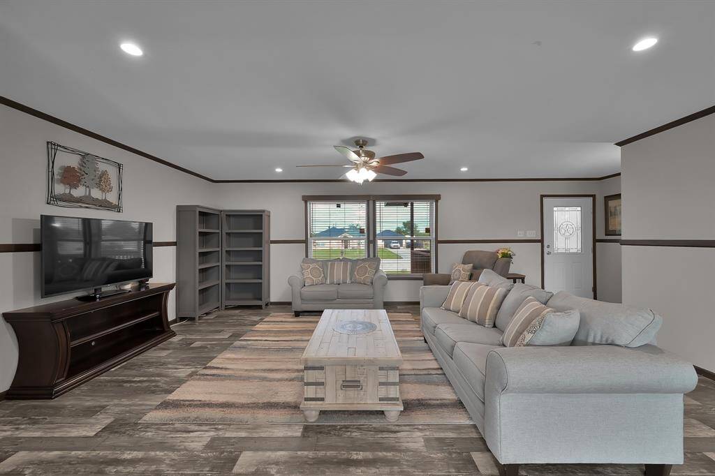Solar window screens, recessed lighting, and ceiling fan lighting help this home stay well lit and cool all year long.