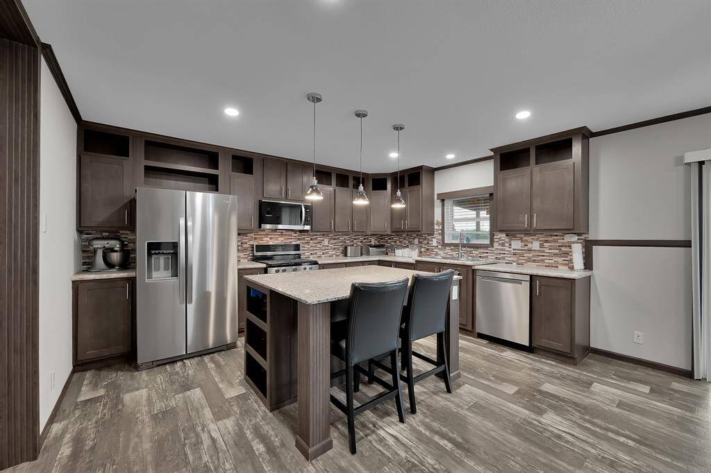 This stately kitchen impresses with its pendant lighting, stylish cabinetry and backsplash.