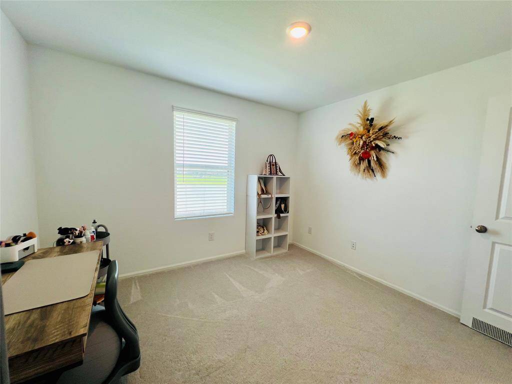 Bright second bedroom with stunning lake views, perfect as a home office.
