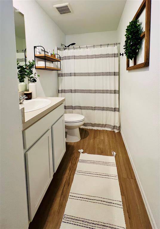 Stylish secondary bathroom with updated black accent shower head, conveniently shared by all upstairs bedrooms.