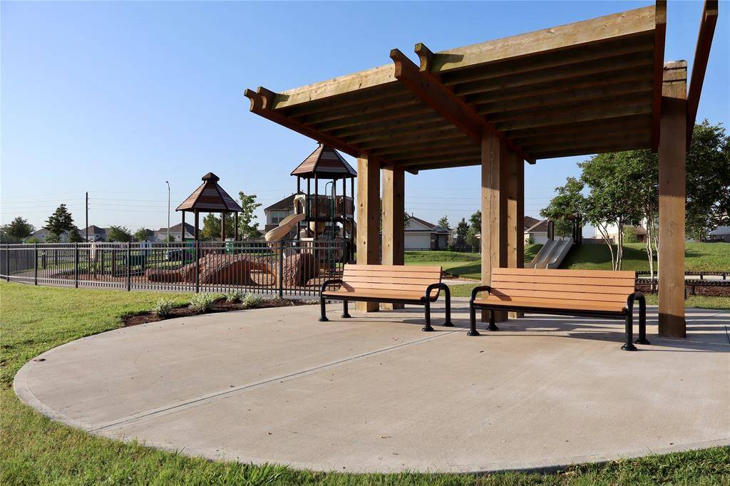 Enjoy the playground with a scenic lakeside pergola and seating, perfect for relaxation while the kids play.