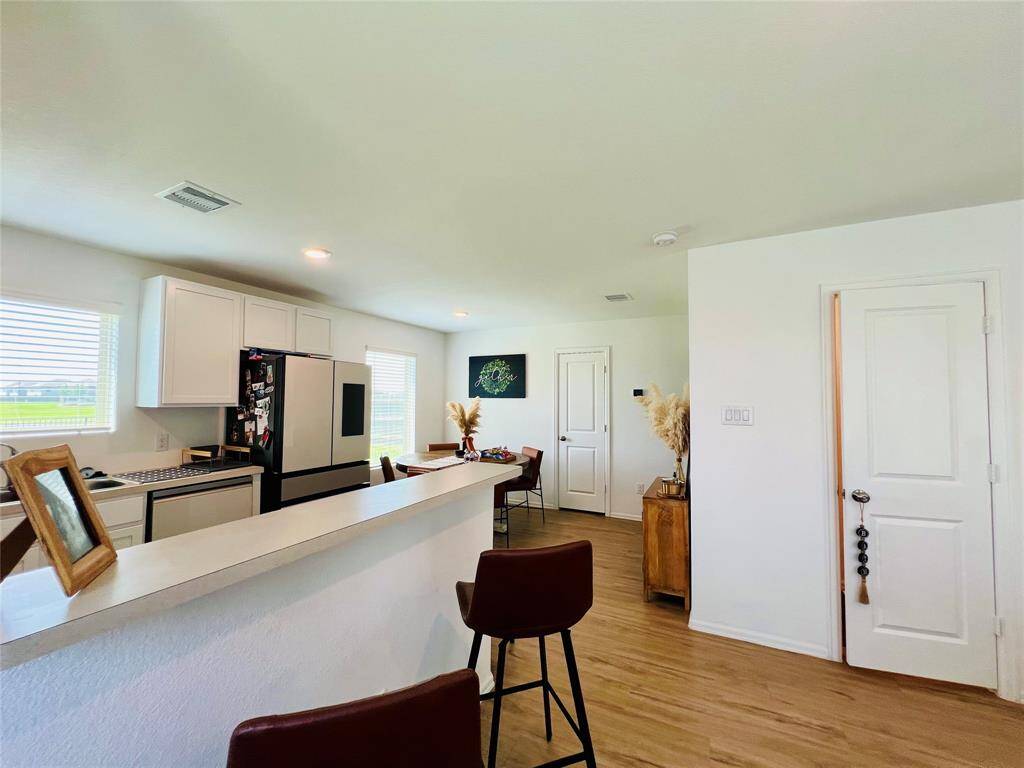 Open-concept kitchen and dining area with convenient guest half bath.