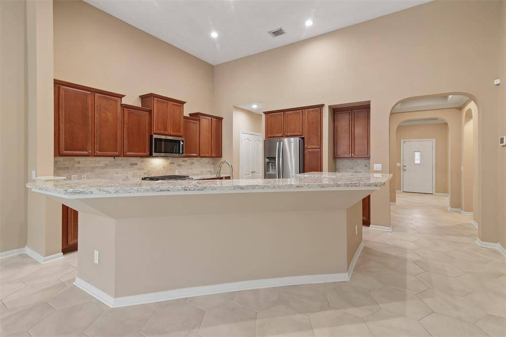 There is a large breakfast bar off the kitchen as well as canned lighting.