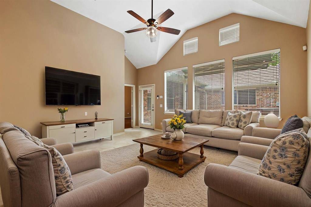 Another view of the family room with wall of windows and access tot he back porch/yard space. *Virtually staged photo*