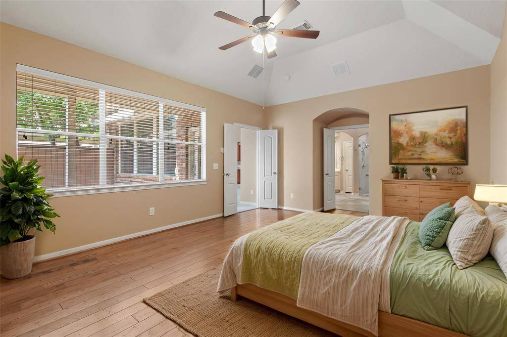 Primary bedroom has double door entry with large window for plenty of natural light. *Virtually staged photo*