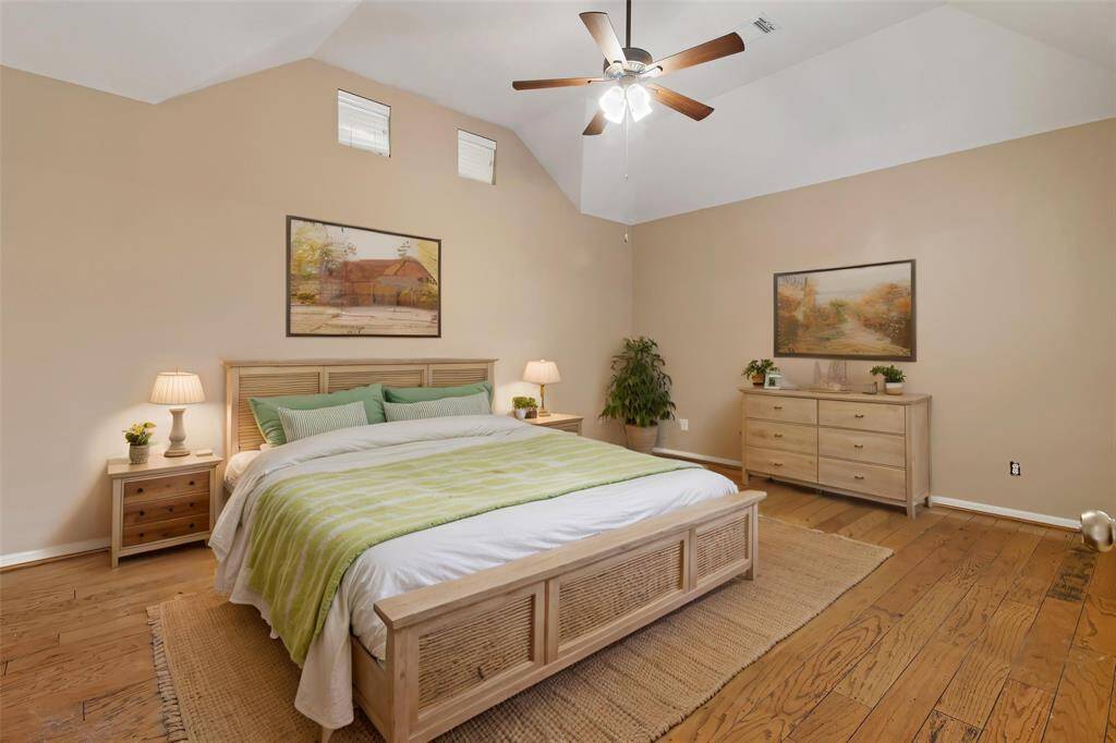 Spacious primary bedroom has wood floors and ceiling fan. *Virtually staged photo, to show the different options for the primary bedroom furniture placement.*