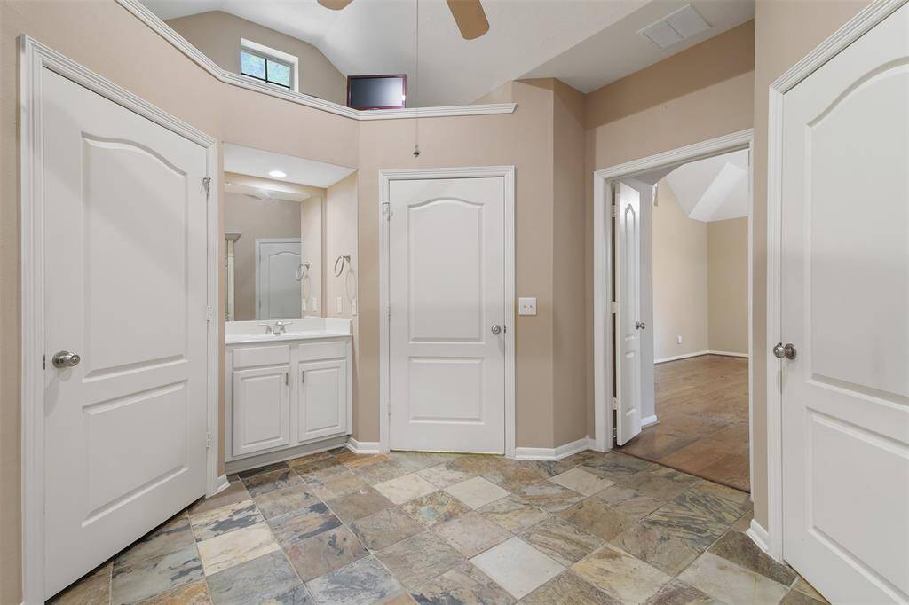 Primary bathroom also has plenty of storage space with walk in closet.