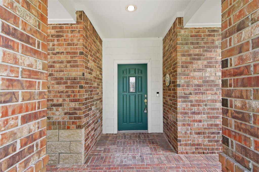 Entry into the home has brick walkway and cover patio area.