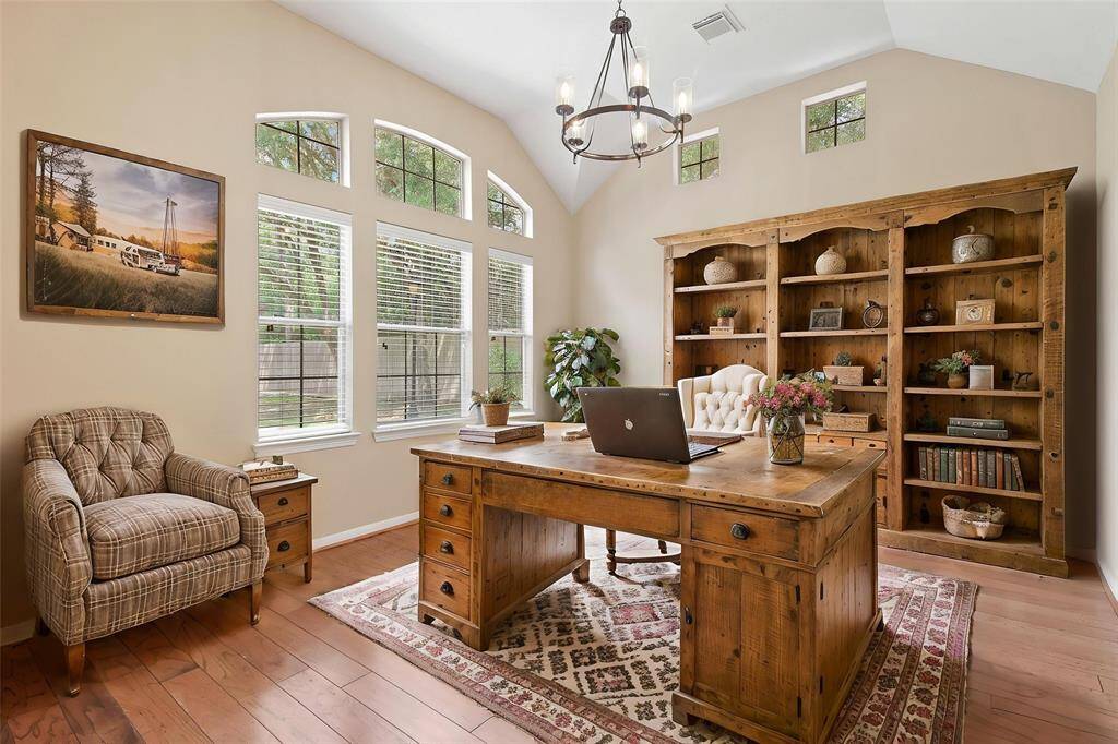 This room can be used as a formal sitting area or study. It has wood floors, large windows and high ceilings. *Virtually staged photo*