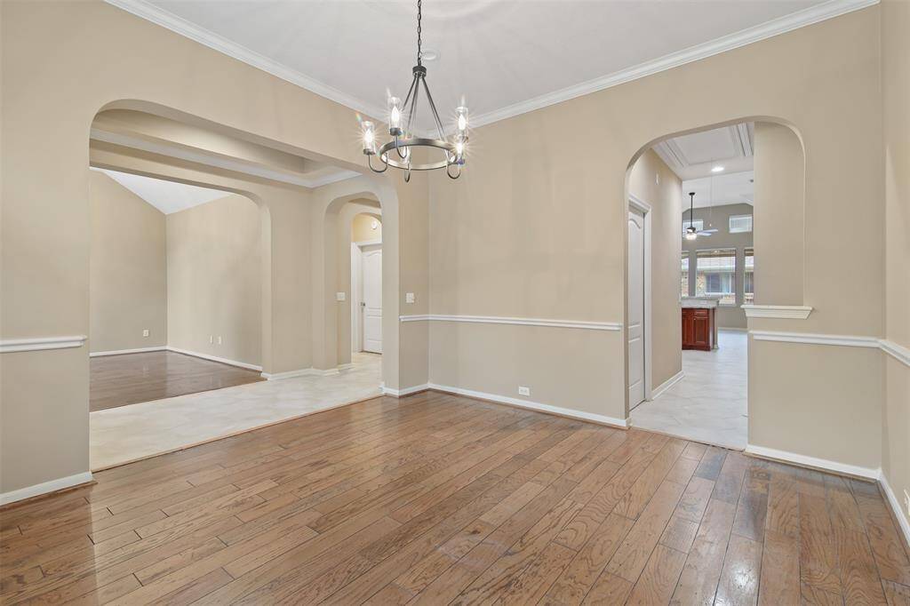 The dining room is just off the kitchen and has arched doorways.