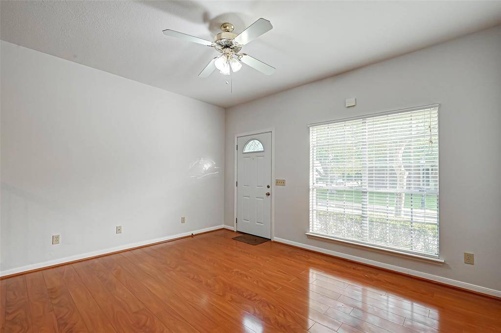 Through the large window, the living area is flooded with natural light.