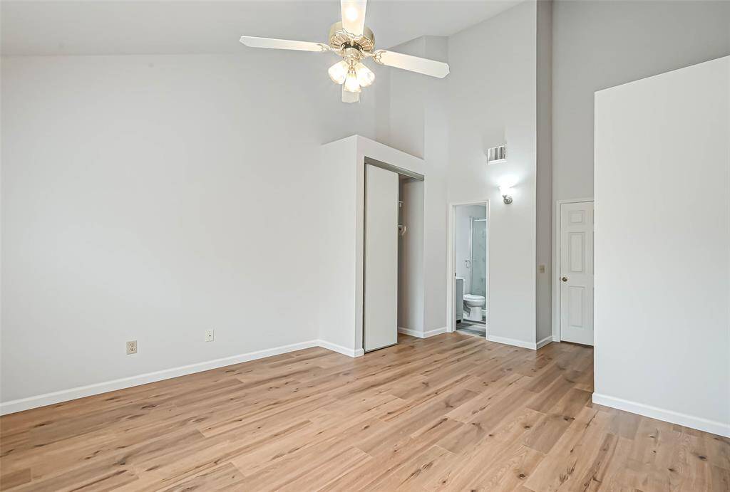 The primary bedroom has a high ceiling..