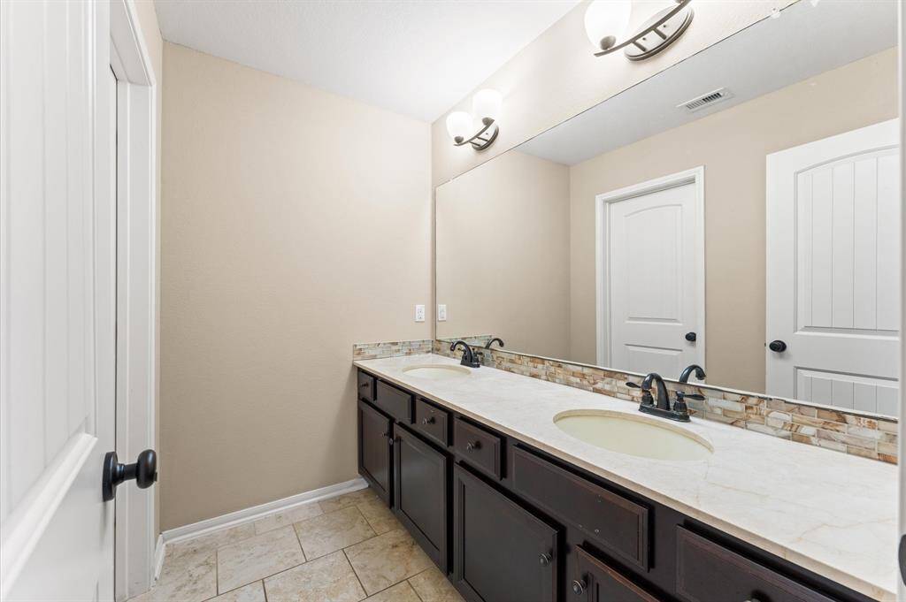 Two sinks are better than one in this convenient his/her bathroom