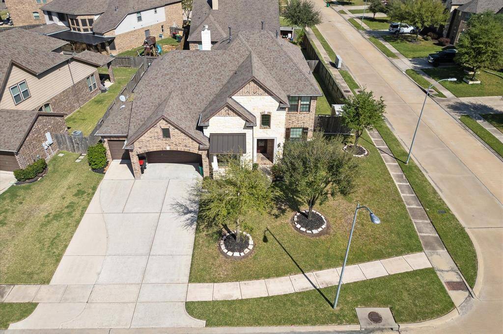 Three car garage. House sits on a corner lot.
