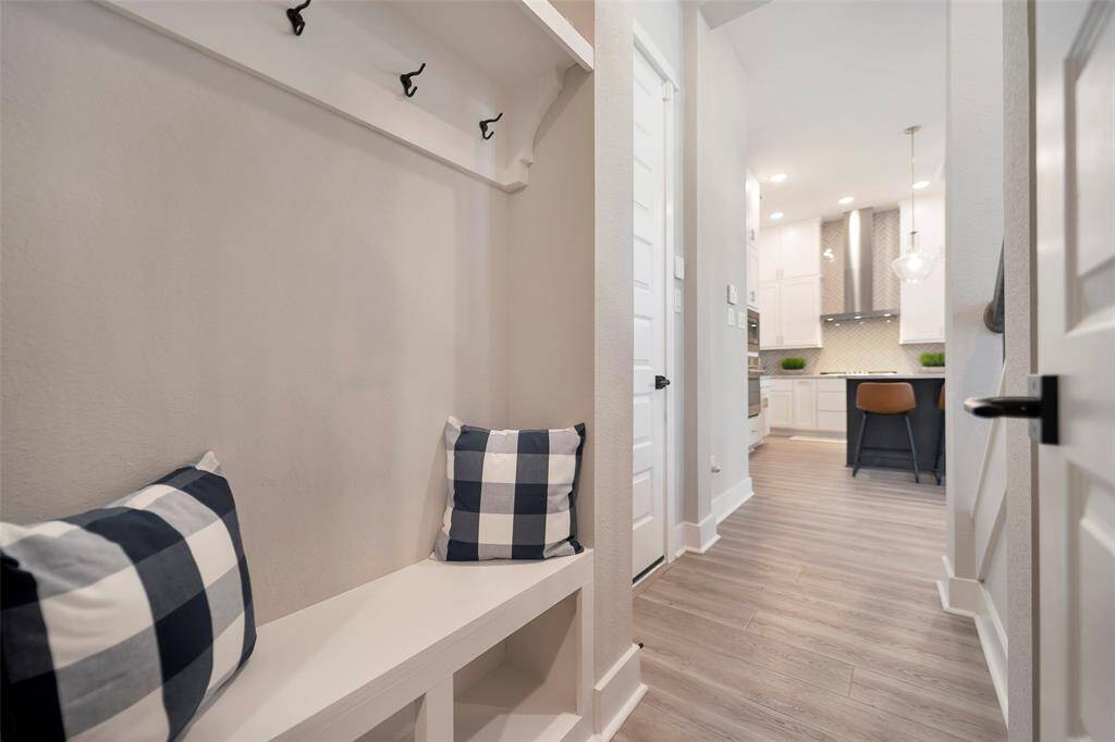 Ample storage under the stairs, in the mudroom & double garage complete with epoxy floors & a fitted storage system.